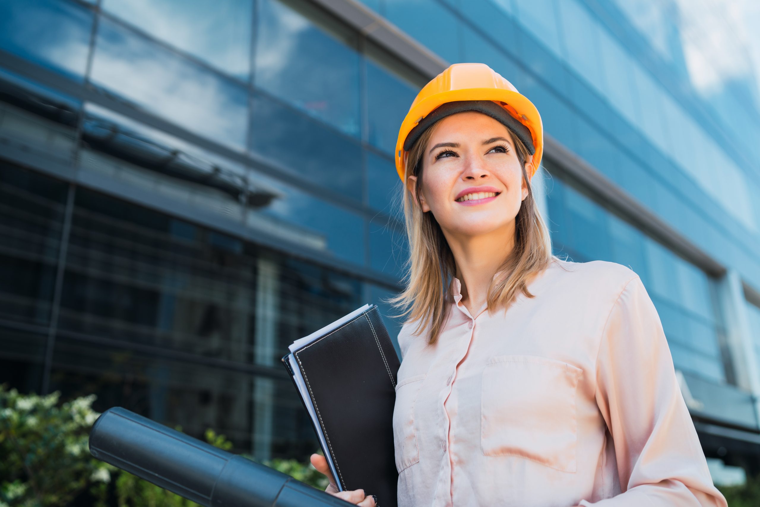 Professional architect woman standing outdoors.